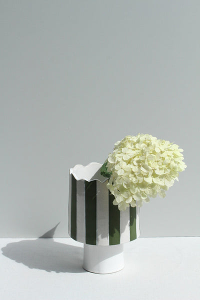 Olive green and white striped vessel or planter with flower