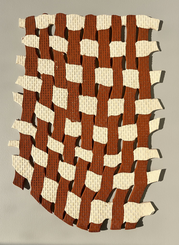 Woven pattern of brown and beige strips on a plain background