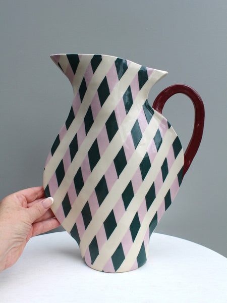 Lilac and dark green geometric ceramic jug. Hand for scale