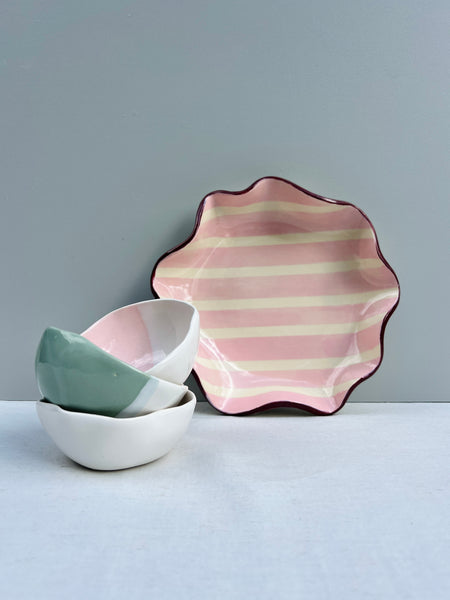 Pink and burgundy ruffle bowl with small dishes