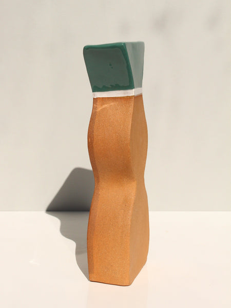 vase with green top on a white background