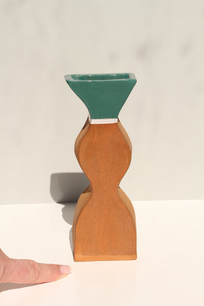 Terracotta and green vase green accent on a white background