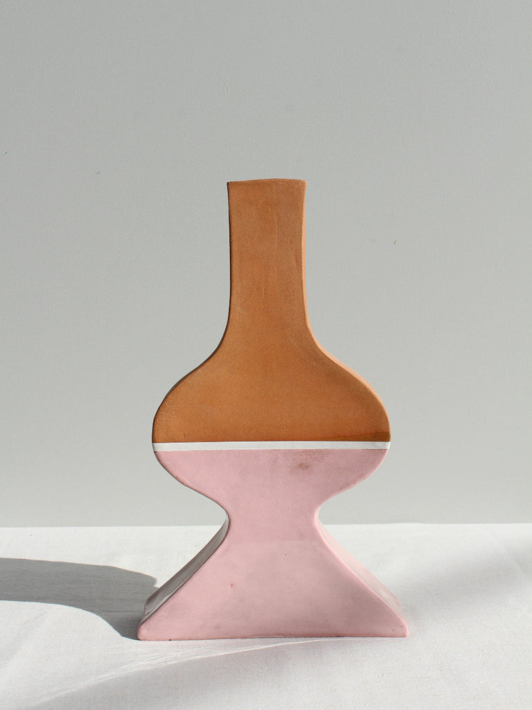 Vase with brown top and pink bottom on a white surface