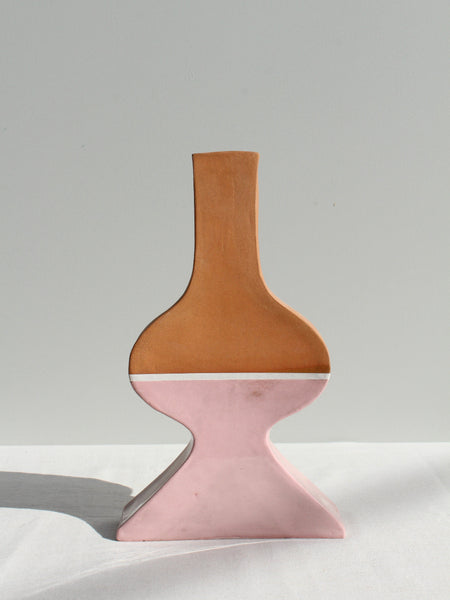Vase with brown top and pink bottom on a white surface