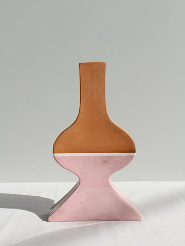 Vase with brown top and pink bottom on a white surface