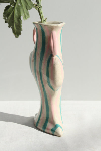 Decorative vase with wavy design on a plain background