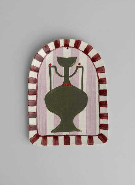 Decorative wall art with a green vase design on a striped background